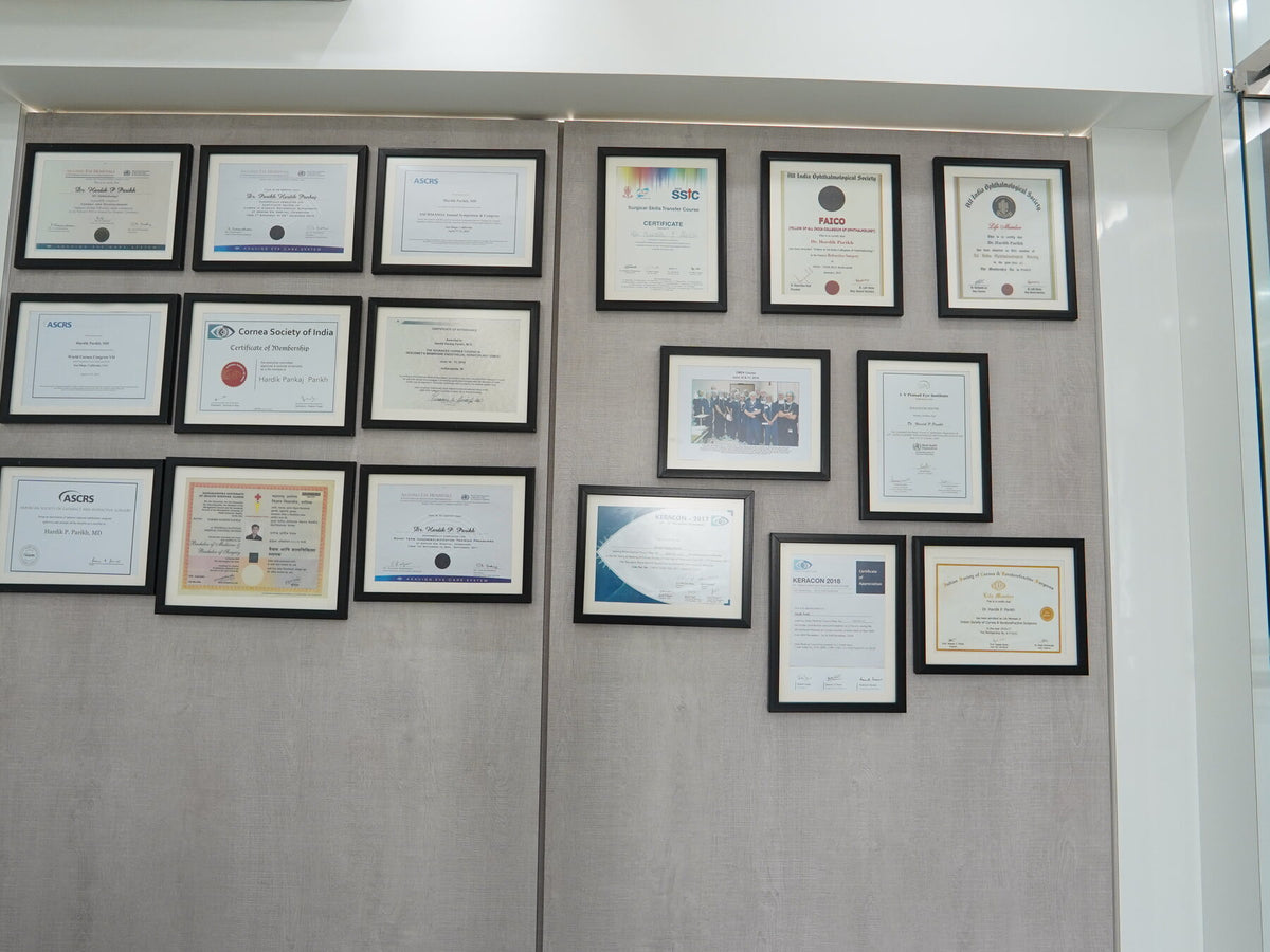 Framed accreditations and certificates on the clinic wall