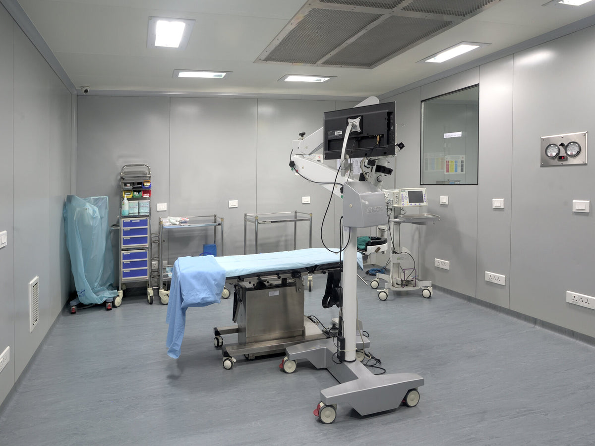Empty ophthalmic operating room with a surgical microscope and patient table